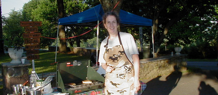 Angi Garasic - KG4AVR of Haymarket, VA. Sets up for breakfast at 6 AM Sunday. Photograph by Norm Styer - AI2C of Clarkes Gap, VA.