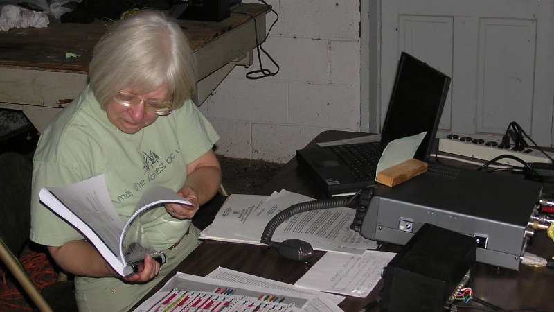 Carol - KF4TJJ rechecks her manual. Photograph by Denny Boehler - KF4TJI of Leesburg, VA.
