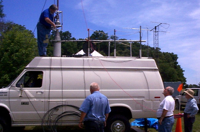 The AMRAD Communications Van's fancy tower gets fitted with all the hardware. Photograph by Meg Gentges - AI4UX of Great Falls, VA.