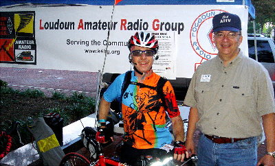 Stephan Greene, KS1G, a.k.a. Bike 1 and Rick Miller, AI1V, a.k.a. Reston (below, lower left) smile for the camera before Sunrise as Stephan prepares to head West on the grueling 100-mile Century Route. Green was riding an APRS-equipped bicycle with a VOX VHF radio. He provided much-needed service during the ride including, at one point, back tracking for a lost biker. Photograph by Jeff Slusher - KE5APC de Leesburg, VA.
