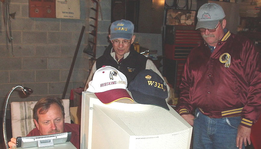 Late on Saturday night, Mark Johnson - W3ZI on 160M CW while John Unger - W4AU and Tom Garasic - NA4MA look on. Photograph by Norm Styer - AI2C de Clarkes Gap, Virginia.