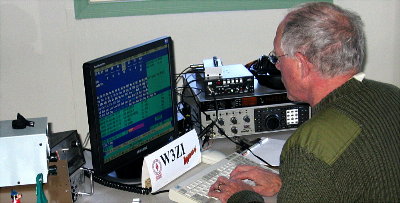 Bill Buchholz - K8SYH takes a turn on the super 20M station. Photograph by Larry Hughes - K3HE of Leesburg, Virginia.