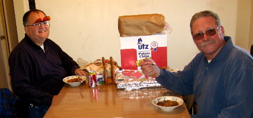 Chester Kmak - WA9LAZ and Tom Garasic - NA4MA sample BA Buchholz's lunch before the action begins. Photograph by Larry Hughes - K3HE of Leesburg, Virginia.