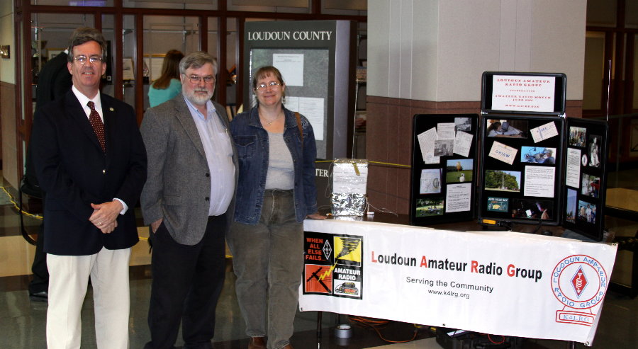 Supervisor Stevens R. Miller of the Dulles District with Tom Dawson - WB3AKD and Suzanne Grobbel in the Lobby of the Loudoun County Government Center with amateur radio display designed and built by Suzanne Grobbel. Photograph by Norm Styer - AI2C de Clarkes Gap, Virginia