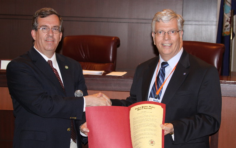 Supervisor Stevens R. Miller of the Dulles District presents Randy Sly - W4XJ with proclamation  of Amateur Radio Month. Photograph by Norm Styer - AI2C de Clarkes Gap, Virginia