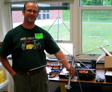 Grant, KB3EMT, shows off his broadband receive antenna. Note the two complete stations set up in the classroom! (Photo credit: Rick Miller-AI1V)